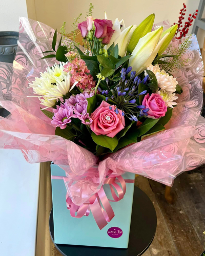 Petal Paradise - A lively bouquet featuring a bright mix of vibrant seasonal blooms. Complemented by lush green foliage and presented in a beautiful packaging, this arrangement is perfect for adding a pop of colour to any occasion