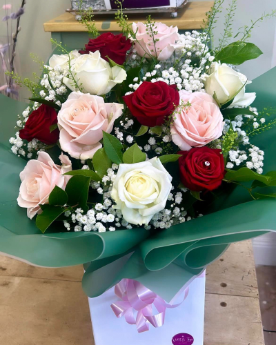 Dreamy Dozen - A hand-tied bouquet delivered in water of 12 high quality pink roses and complementary filler wrapped in paper/ cellophane in a box / bag.